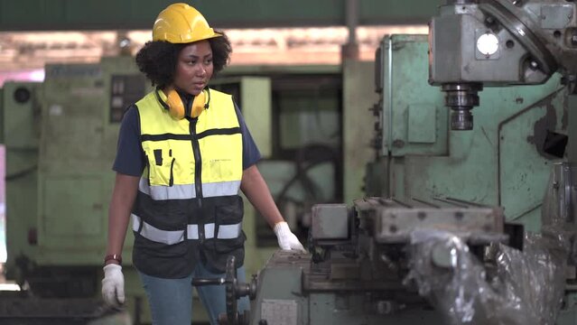 African American tired worker woman hard working sweat dirty gloves repair old machine in industrial manufacturing factory. black female labor mechanic engineer maintenance and check. hot weather