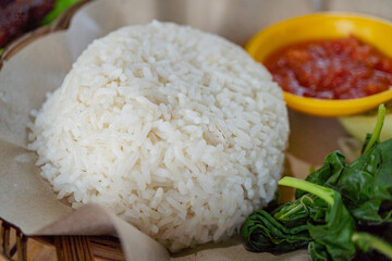 Chicken crispy with spicy sauce, vegetables and rice. The photo is suitable to use for food background, poster and food content media.