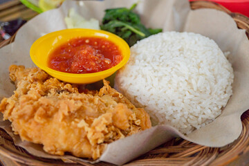 Chicken crispy with spicy sauce, vegetables and rice. The photo is suitable to use for food background, poster and food content media.