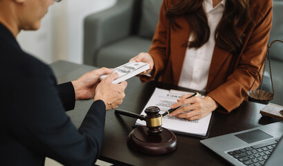 justice and law concept.passing bribe money in the envelop at office. businessman hand taking bribe...