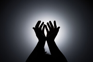 Silhouette photo, A young woman prayed for God's blessings with the power and holiness of God on...