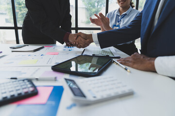 Businessman team congratulates employees, his teammates for successful team performance, financial business, growth, profit. Outstanding perfect agreement with handshake in office.