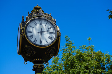 Fototapeta na wymiar old public clock indicating the time 14.30.