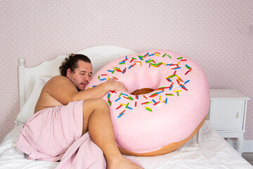 Diet and sweet snacks. Funny fat man dreams about donuts and cakes.