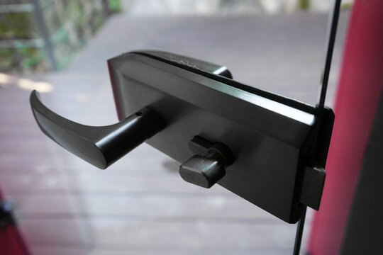 iron Door handle. transparent glass door.  close up image.