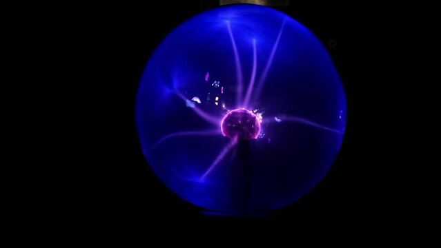 Tesla coil. Plasma globe. Blue and purple light beams. Energy rays moving from side to side. Coil electric discharge. Close-up. Magic object. Plasma Sphere Static Electricity. Decoration.