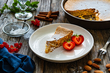 Tarta de Santiago - Spanish almond cake on wooden background
