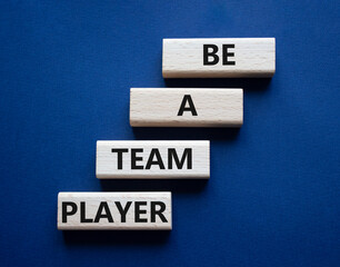 Be a team player symbol. Concept words Be a team player on wooden blocks. Beautiful deep blue background. Business and Be a team player concept. Copy space