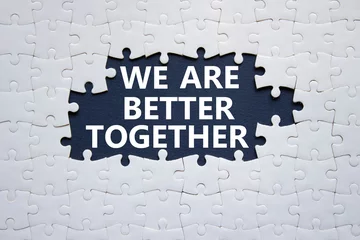 Fotobehang We are better together symbol. White puzzle with words We are better together. Beautiful black background. We are better together concept. Copy space. © Natallia