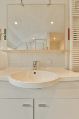 a white bathroom with a sink and mirror in the corner on the wall above it is a towel rack that has been used for