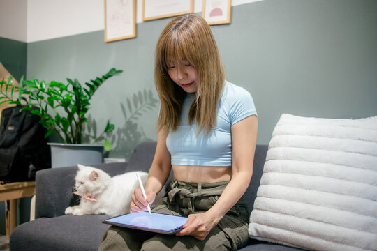 Woman take notes and drawing a digital illustration on a tablet computer