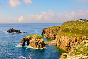 Land's End, one of the UK's most famous tourist attractions. The arch is Enys Dodnan, the rock formation is the Armed Knight. The Land's End attraction is at top right.