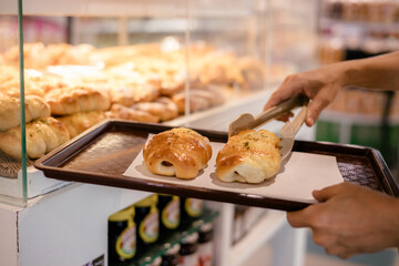 Close up photo of woman chooses bread in the store