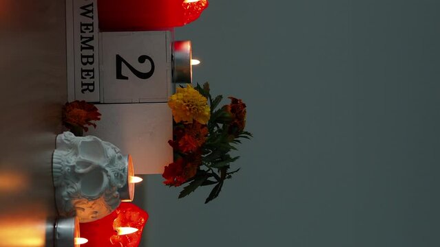 Day of the dead background, vertical video. Calendar with the date November 2 Traditional Mexican holiday. Video for stories with a skull, candles and flowers.