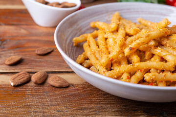 Sicilian pasta with almond and tomatoes pesto. Typical Italian food from Sicily, pasta with red pesto.