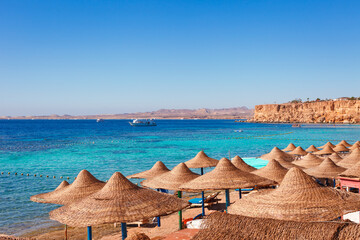 Sunny resort beach on the Red Sea in Sharm el Sheikh, Sinai, Egypt - obrazy, fototapety, plakaty