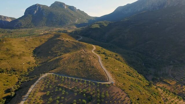 aerial drone footage of beautiful scenic landscape of Marmaris peninsula, mountains and hills with green woods and curved road to Datca destination. peninsula surrounded Aegian and Mediterranean seas.