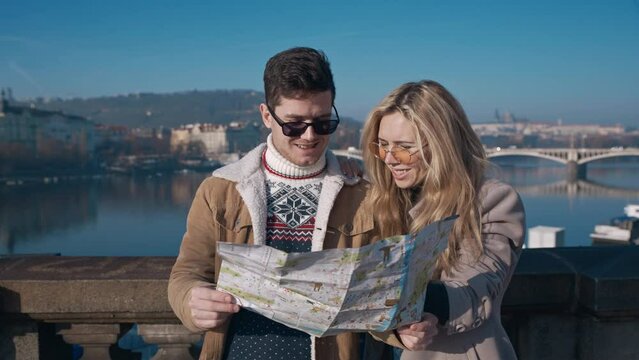 Young tourists examining the map of Prague. Tourism, travel, friendship, love, concept. Filmed on REd 4k, 10 bit color