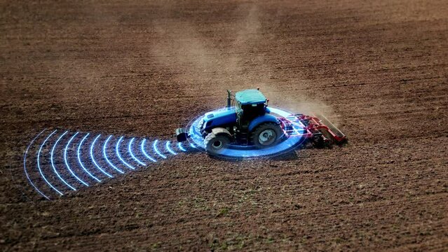 5G self-driving autonomous tractor without driver working the soil. Smart agriculture farming concept. Scanning the surrounding environment with sensors and radar, artificial intelligence technology. 