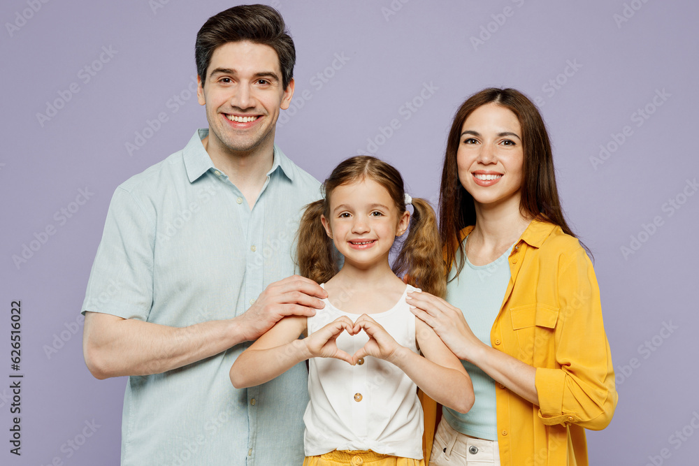 Poster Young parents mom dad with child kid daughter girl 6 year old wear blue yellow casual clothes show shape heart with hands heart-shape sign, hug isolated on plain purple background Family day concept