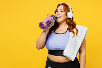 Young chubby overweight plus size big fat fit woman wears blue top warm up training listen to music...
