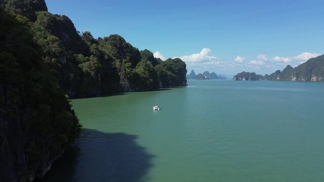 Phang Nga National Park in southern Thailand, drone flight along Panak Island, sailing yacht stands near the island