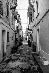 Obraz premium Small, narrow, mediterranean old town alley. Clotheslines and power cables are stretched from house to house. 