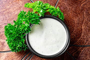 tartar sauce in a bowl on a wooden table