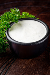 tartar sauce in a bowl on a wooden table