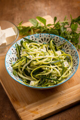 raw zucchinis salad with feta cheese