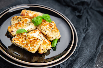 fried halloumi cheese with basil healthy meal food snack on the table copy space food background rustic top view keto or paleo diet veggie vegan or vegetarian food