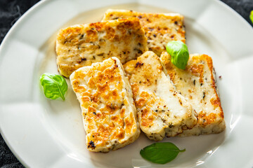 fried halloumi cheese with basil healthy meal food snack on the table copy space food background rustic top view keto or paleo diet veggie vegan or vegetarian food