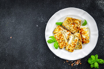 fried halloumi cheese with basil healthy meal food snack on the table copy space food background rustic top view keto or paleo diet veggie vegan or vegetarian food