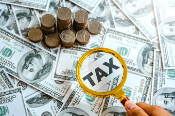 Hand with magnifier  search for income tax return form online for tax payment. Government, state taxes. Data analysis, paperwork, financial research