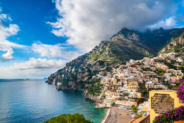 View of Positano beach and houses on the hills - obrazy, fototapety, plakaty