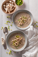 Vegan mushroom shimeji soup with chives and cream.