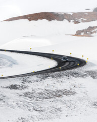 Car driving down a snowy road in Iceland