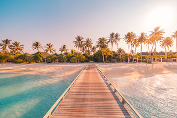 Amazing sunset panorama at Maldives. Luxury resort villas seascape with soft led lights under colorful sky. Beautiful twilight sky and colorful clouds. Beautiful beach background for vacation holiday - obrazy, fototapety, plakaty