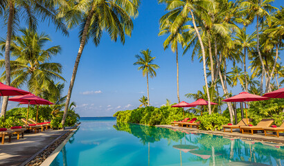 Panoramic holiday landscape. Luxury beach poolside resort hotel swimming pool, beach chairs beds umbrellas palm trees, relax lifestyle, blue sunny sky. Summer island seaside, leisure travel vacation - obrazy, fototapety, plakaty