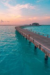 Sunset on Maldives island, luxury water villas resort, wooden pier. Beautiful colorful sky clouds...