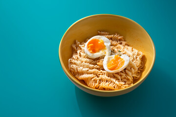 Boiled instant noodles on a blue background.
