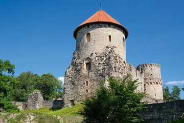 Fototapeta na wymiar Latvian tourist landmark attraction - Ruins of the medieval Livonian castle, stone walls and towers in Cesis, Latvia.