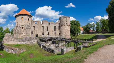 Latvian tourist landmark attraction - ruins of the medieval Livonian castle, stone walls and towers  in old Cesis town, Latvia.
