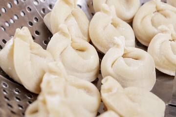 Homemade dumplings in the steamer basket prepared to be cooked. Dumplings closeup.