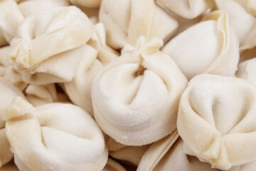 Frozen uncooked dumplings closeup. Macro shot.