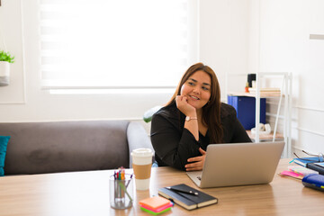 Cheerful relaxed woman and boss at her office desk