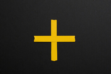 Plus yellow sign, symbol on black background