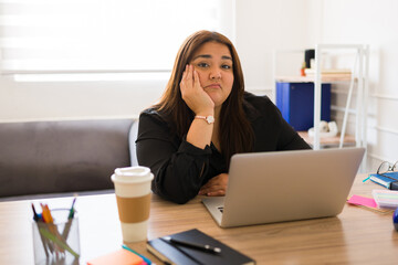Worried tired woman with a lot of work feeling exhausted