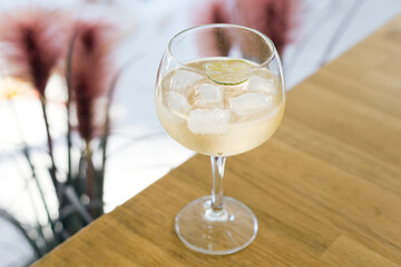 refreshing drink glass with ice on table. cubes crystal clear water. healthy lemonade on hot days