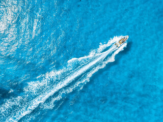 Vacation and leisure. Aerial view on fast boat on blue Mediterranean sea at sunny day. Fast ship on the sea surface. Seascape from the drone. Seascape from air. Seascape with motorboat.